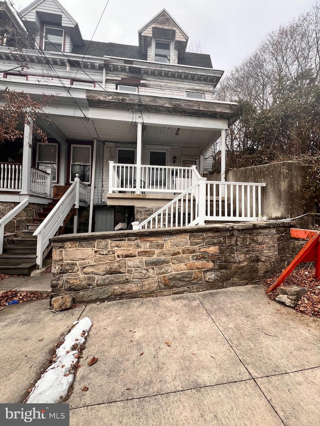 rear view of property with covered porch