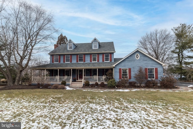 colonial house featuring a lawn and a porch