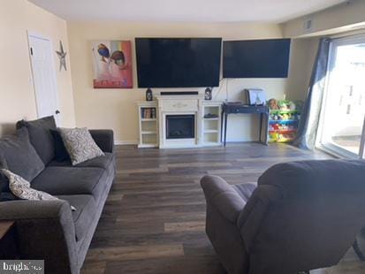 living room with hardwood / wood-style flooring and a fireplace