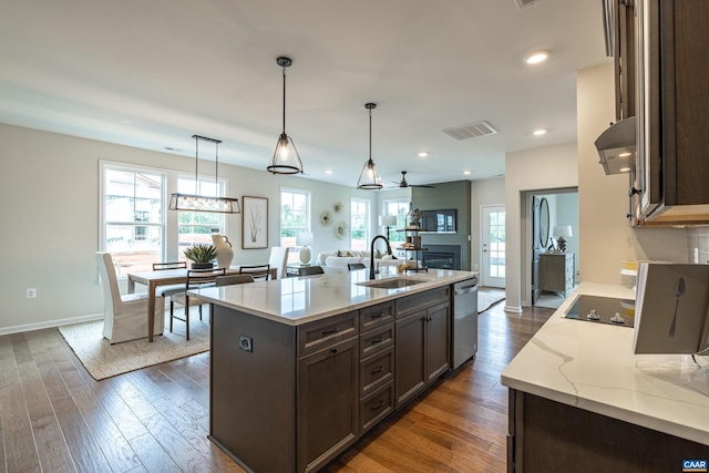 kitchen with dishwasher, a center island with sink, ceiling fan, dark hardwood / wood-style flooring, and sink