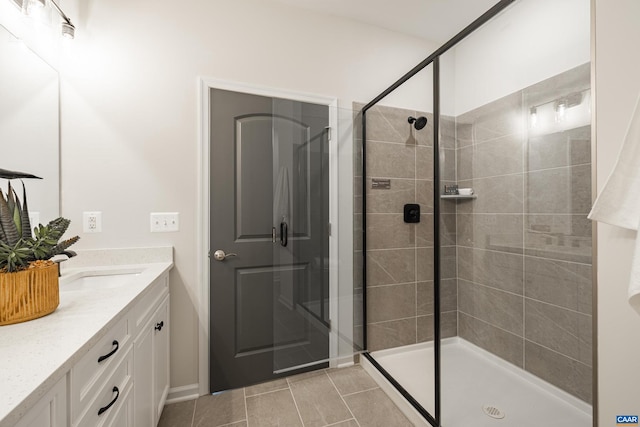 bathroom featuring vanity, a shower with door, and tile patterned flooring