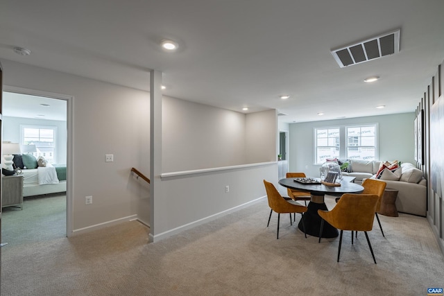 carpeted dining room featuring a wealth of natural light