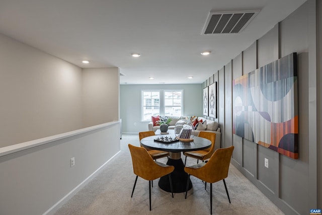 dining area featuring light colored carpet