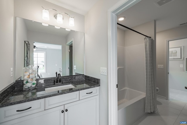 bathroom featuring ceiling fan, shower / bath combo with shower curtain, and vanity