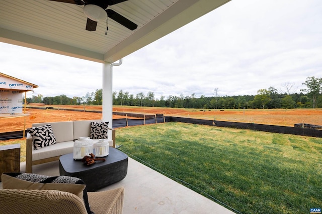 view of patio / terrace with an outdoor hangout area, ceiling fan, and a rural view