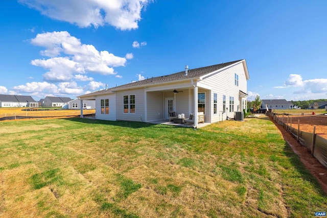 back of house featuring ceiling fan, a yard, central AC, and a patio area