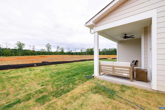 view of yard with an outdoor hangout area, a rural view, and ceiling fan