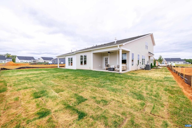 back of property with ceiling fan, a patio, cooling unit, and a yard