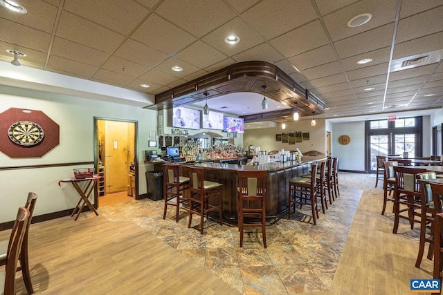 bar with light wood-type flooring