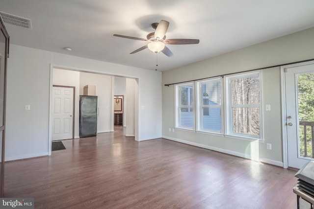 unfurnished living room with ceiling fan and hardwood / wood-style flooring