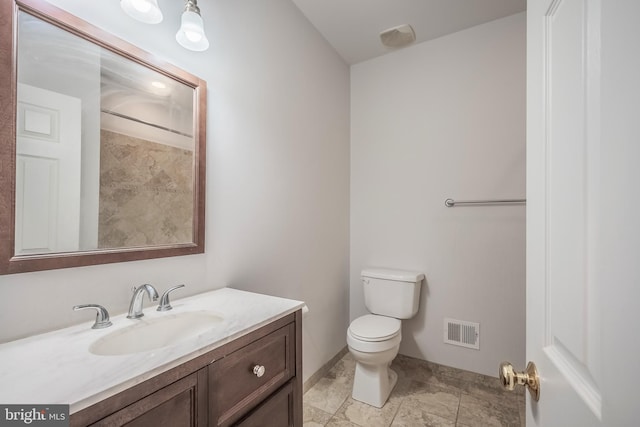 bathroom with toilet and vanity