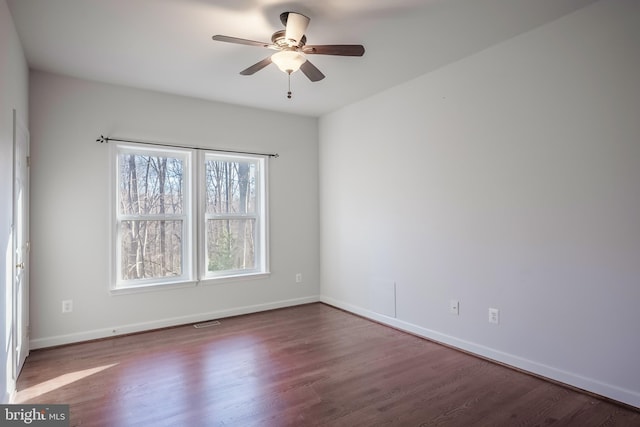 empty room featuring ceiling fan and hardwood / wood-style flooring