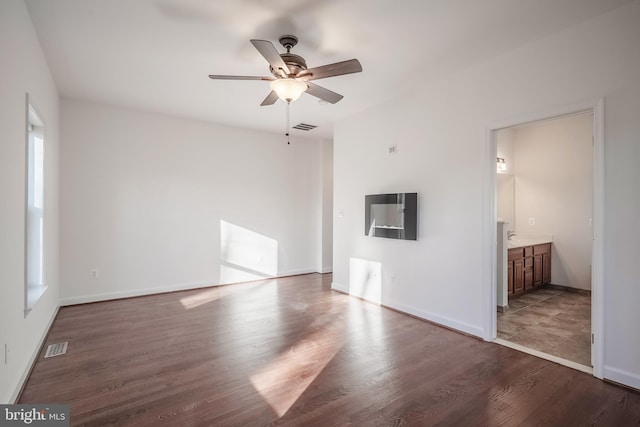 unfurnished living room featuring ceiling fan and hardwood / wood-style flooring