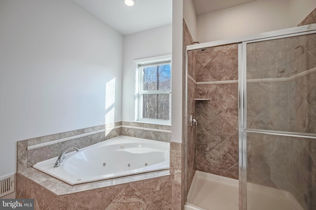 bathroom featuring shower with separate bathtub