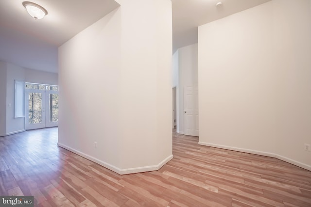 spare room featuring light wood-type flooring and french doors