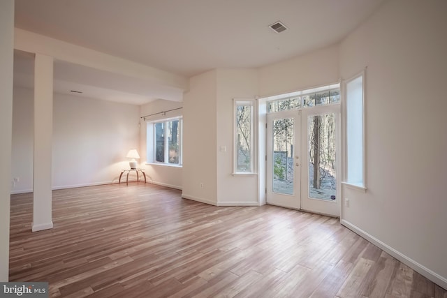 interior space with french doors and light wood-type flooring