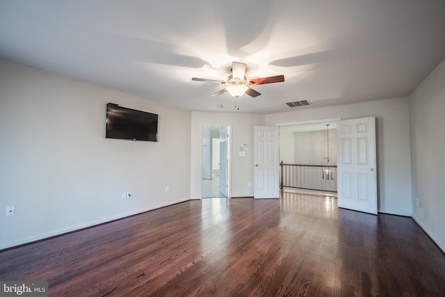 unfurnished living room featuring ceiling fan and dark hardwood / wood-style floors