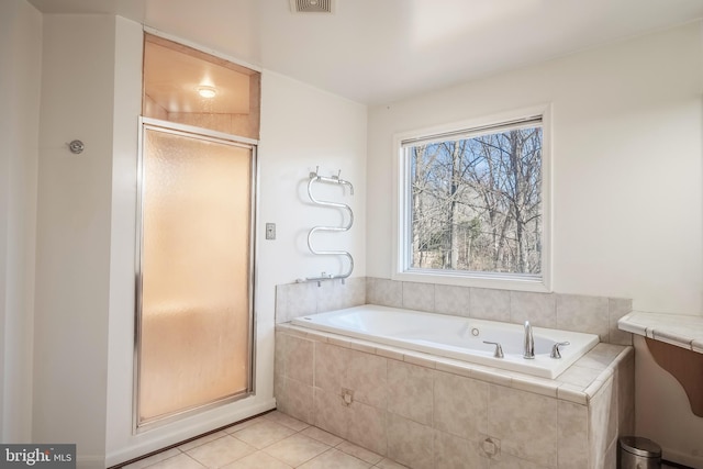 bathroom with independent shower and bath and tile patterned flooring