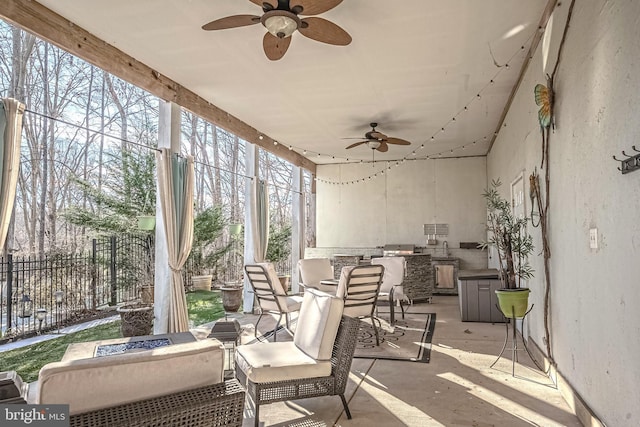 sunroom featuring ceiling fan