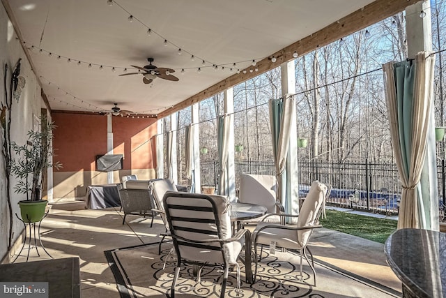 sunroom / solarium featuring ceiling fan