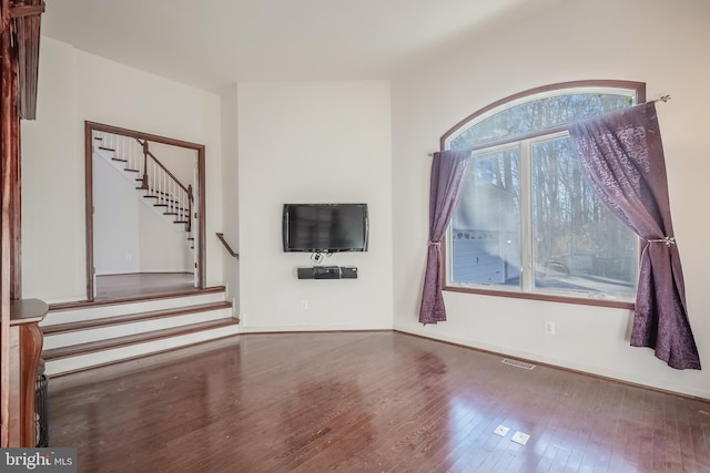 unfurnished living room featuring dark hardwood / wood-style flooring