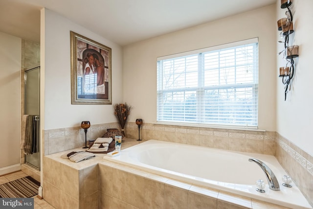 bathroom with plenty of natural light and independent shower and bath