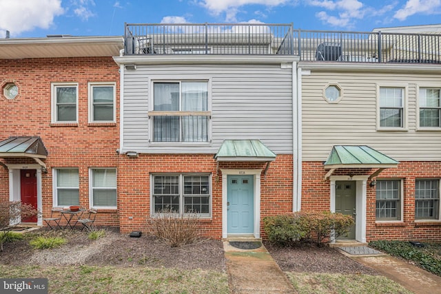 townhome / multi-family property featuring brick siding