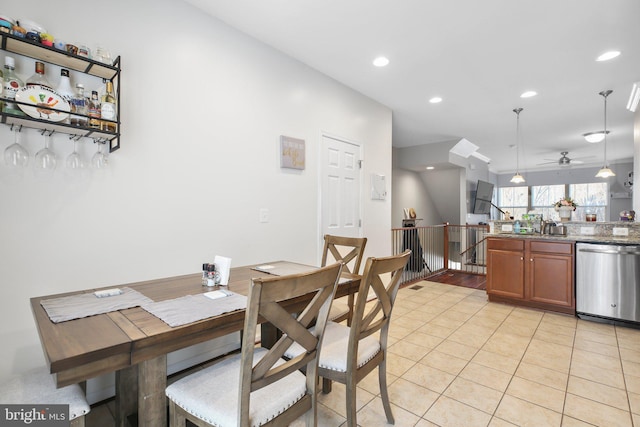 dining space featuring ceiling fan and light tile patterned floors