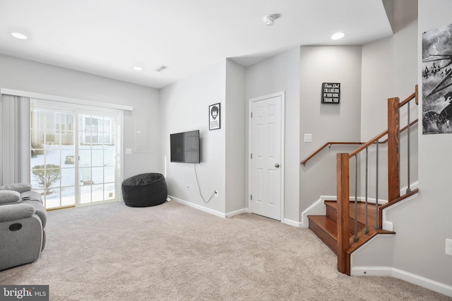 living area featuring light carpet