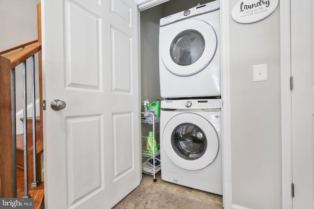 clothes washing area with stacked washer / drying machine