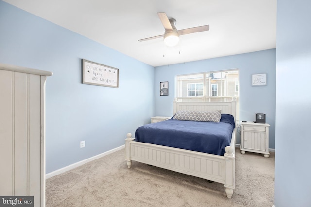 bedroom with light carpet and ceiling fan