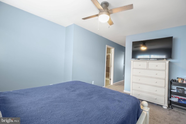 unfurnished bedroom with ensuite bath, ceiling fan, and light colored carpet