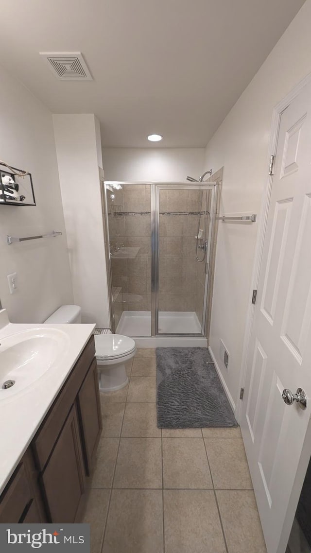 bathroom with toilet, walk in shower, tile patterned floors, and vanity