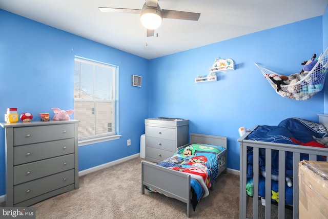 bedroom featuring light carpet and ceiling fan