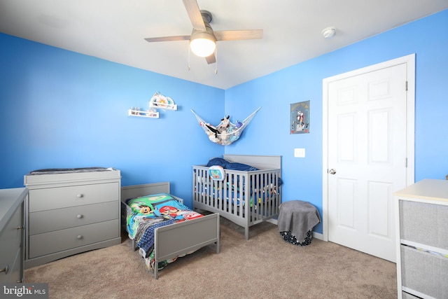 bedroom featuring light colored carpet and ceiling fan