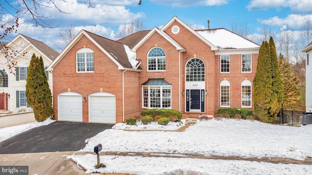 view of front of house with cooling unit and a garage