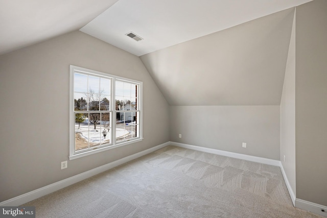 bonus room featuring lofted ceiling and light carpet