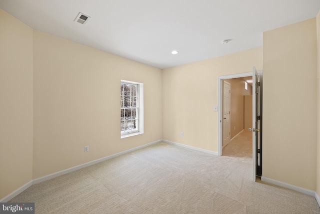 unfurnished room with light carpet