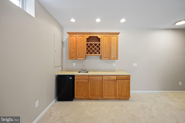 kitchen with sink, light carpet, and refrigerator