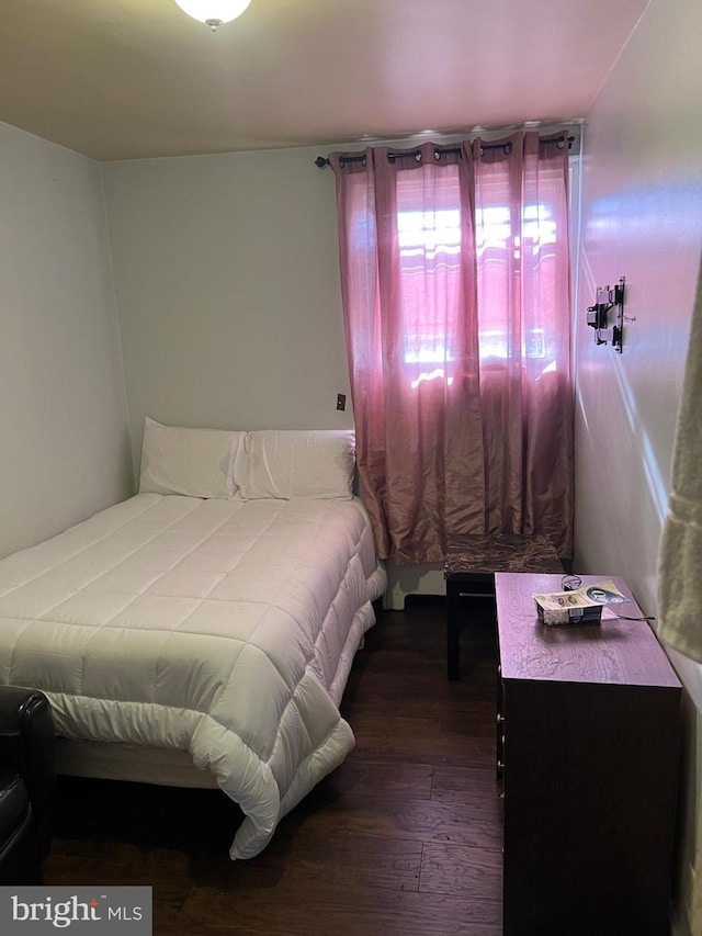 bedroom featuring dark hardwood / wood-style flooring