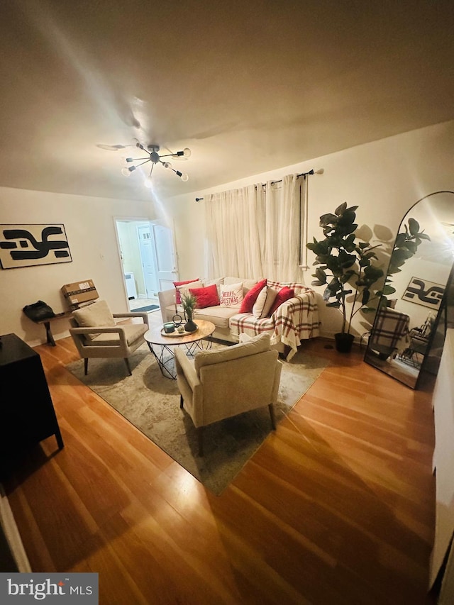 living room with wood-type flooring and ceiling fan