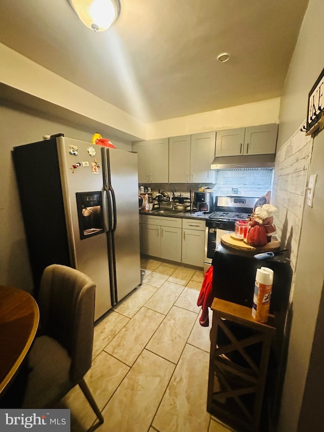 kitchen featuring gray cabinets, appliances with stainless steel finishes, sink, light tile patterned flooring, and tasteful backsplash