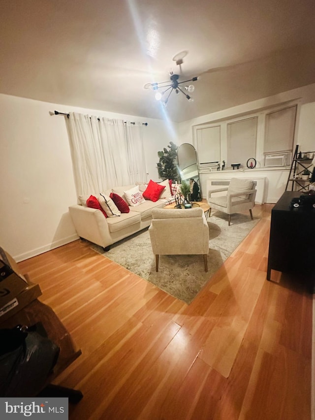 living room with a chandelier and hardwood / wood-style floors