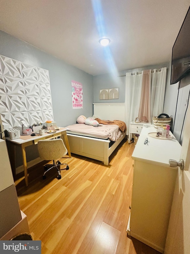 bedroom with light hardwood / wood-style floors