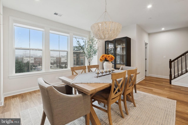 dining room with an inviting chandelier and light wood-type flooring