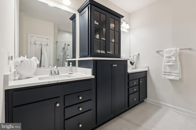 bathroom with vanity, tile patterned floors, and walk in shower