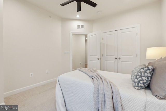 carpeted bedroom featuring ceiling fan and a closet