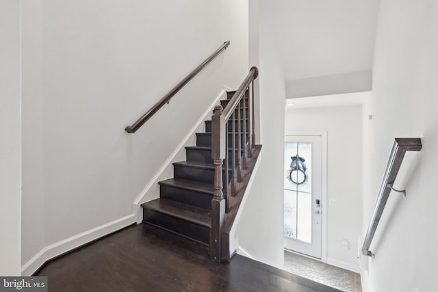 stairs with hardwood / wood-style floors