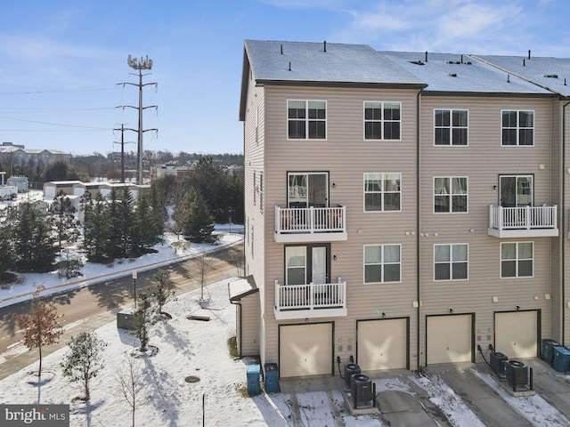 snow covered property featuring central air condition unit