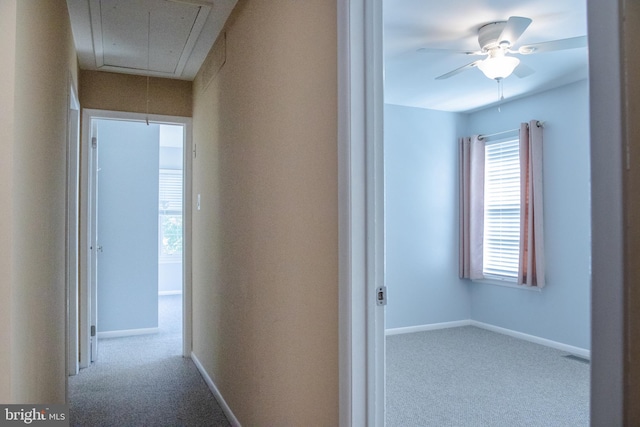 hall with light colored carpet